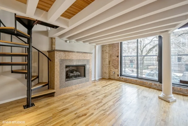 Loft with spiral staircase and fireplace in Chicago