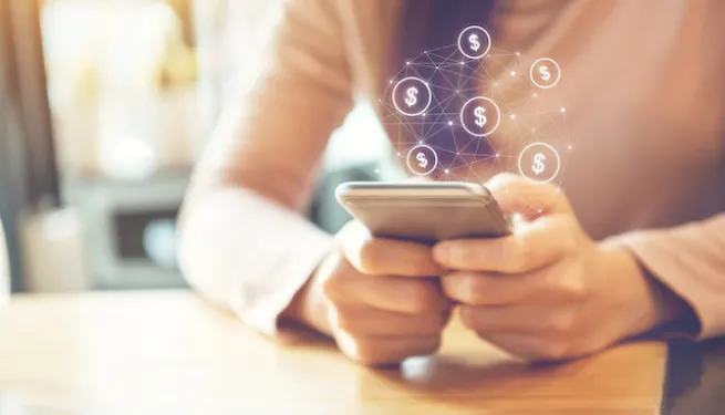 holding_smartphone_with_dollar_signs_blog_image