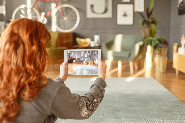 woman holding tablet taking photo of apartment interior_resized