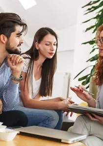a landlord explaining terms of an apartment lease agreement to a couple of renters in Chicago