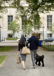 couple walking a black dog in the South Loop neighborhood of Chicago