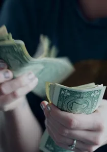 a person counting money by hand
