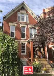 red_brick_apartment_building_with_fall_accents_in_front_blog_image