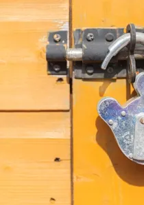 steel padlock on yellow door