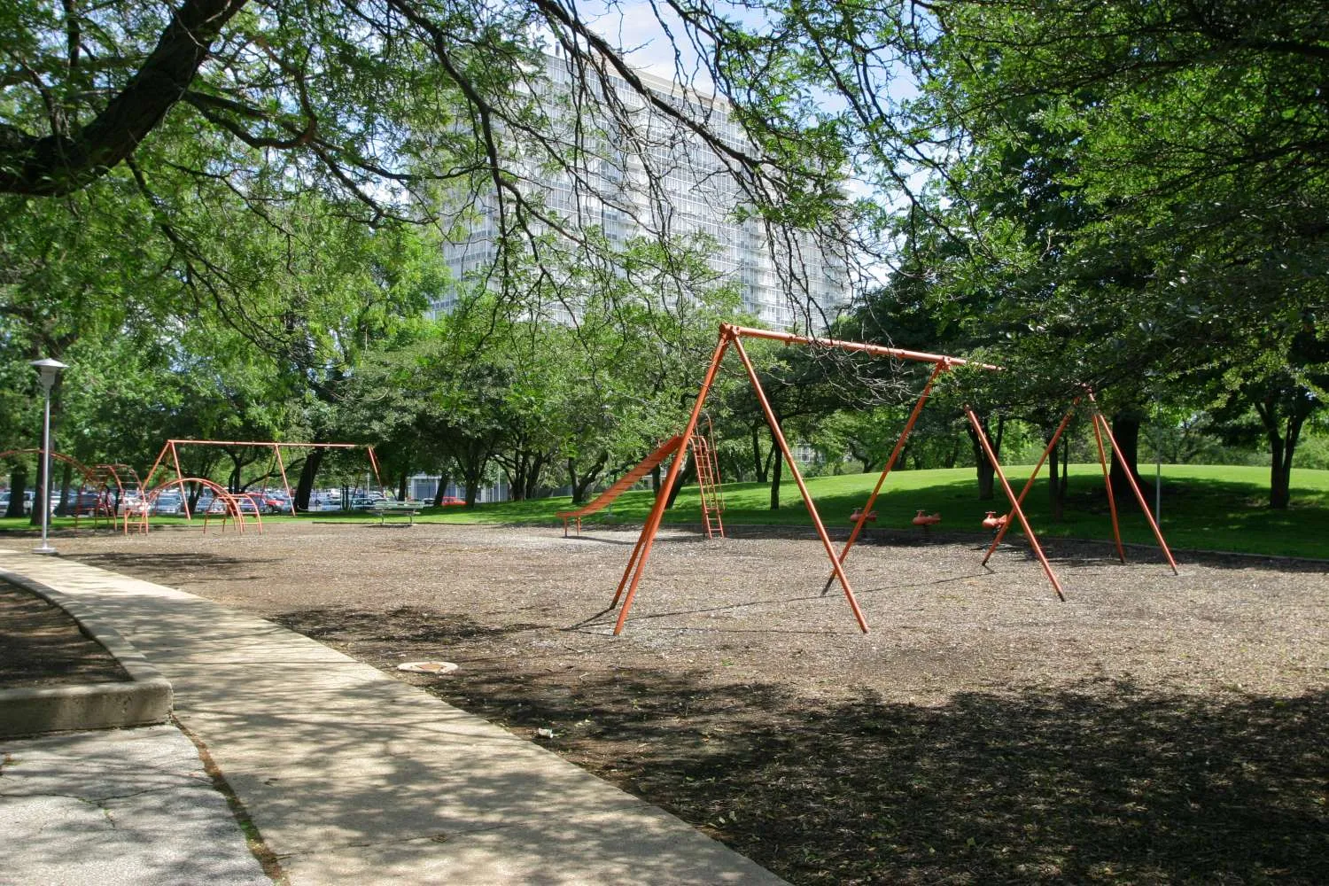 trees in front of the glass Lake Meadows Apartments in Bronzeville Chicago