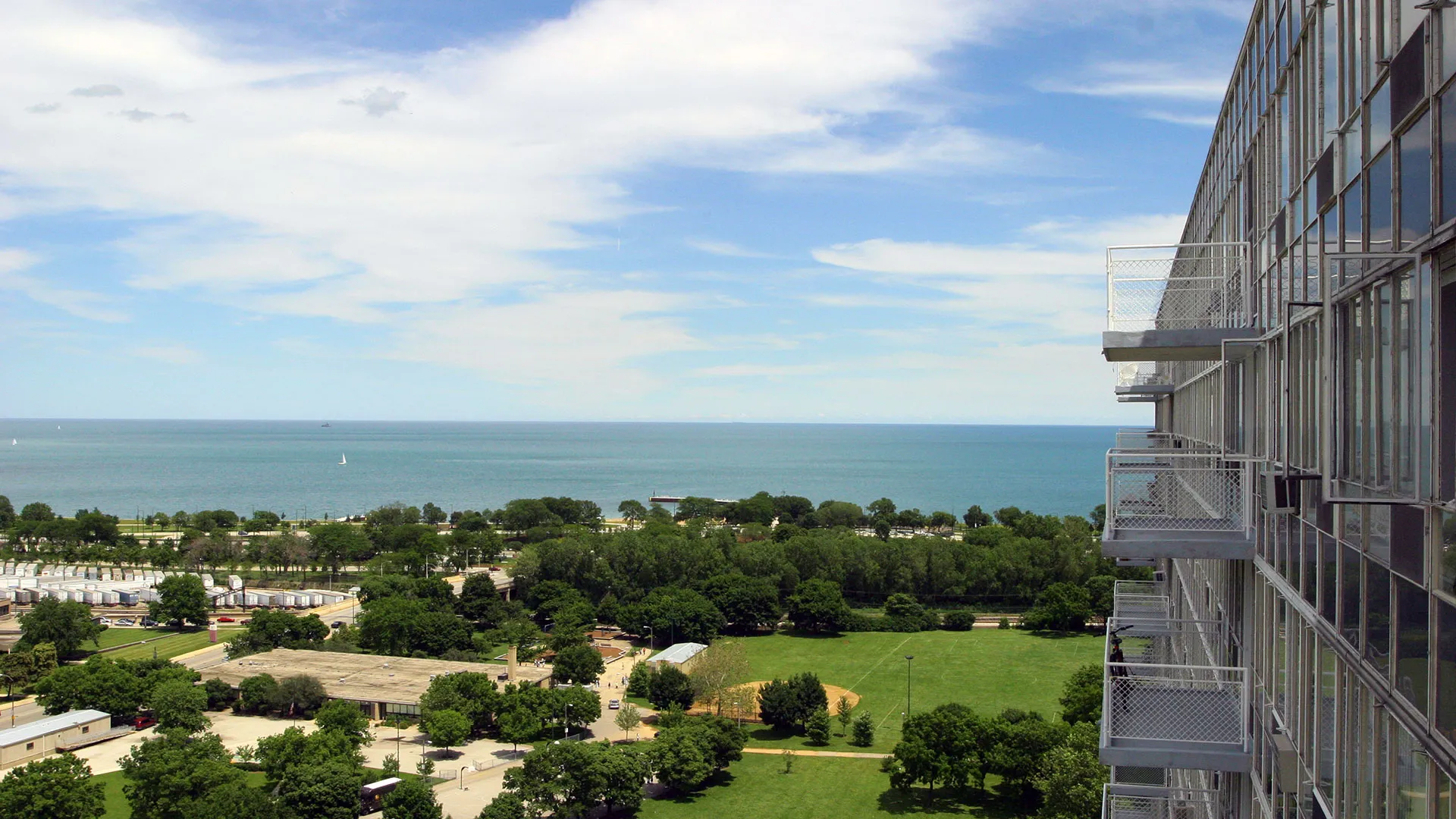 trees in front of the glass Lake Meadows Apartments in Bronzeville Chicago