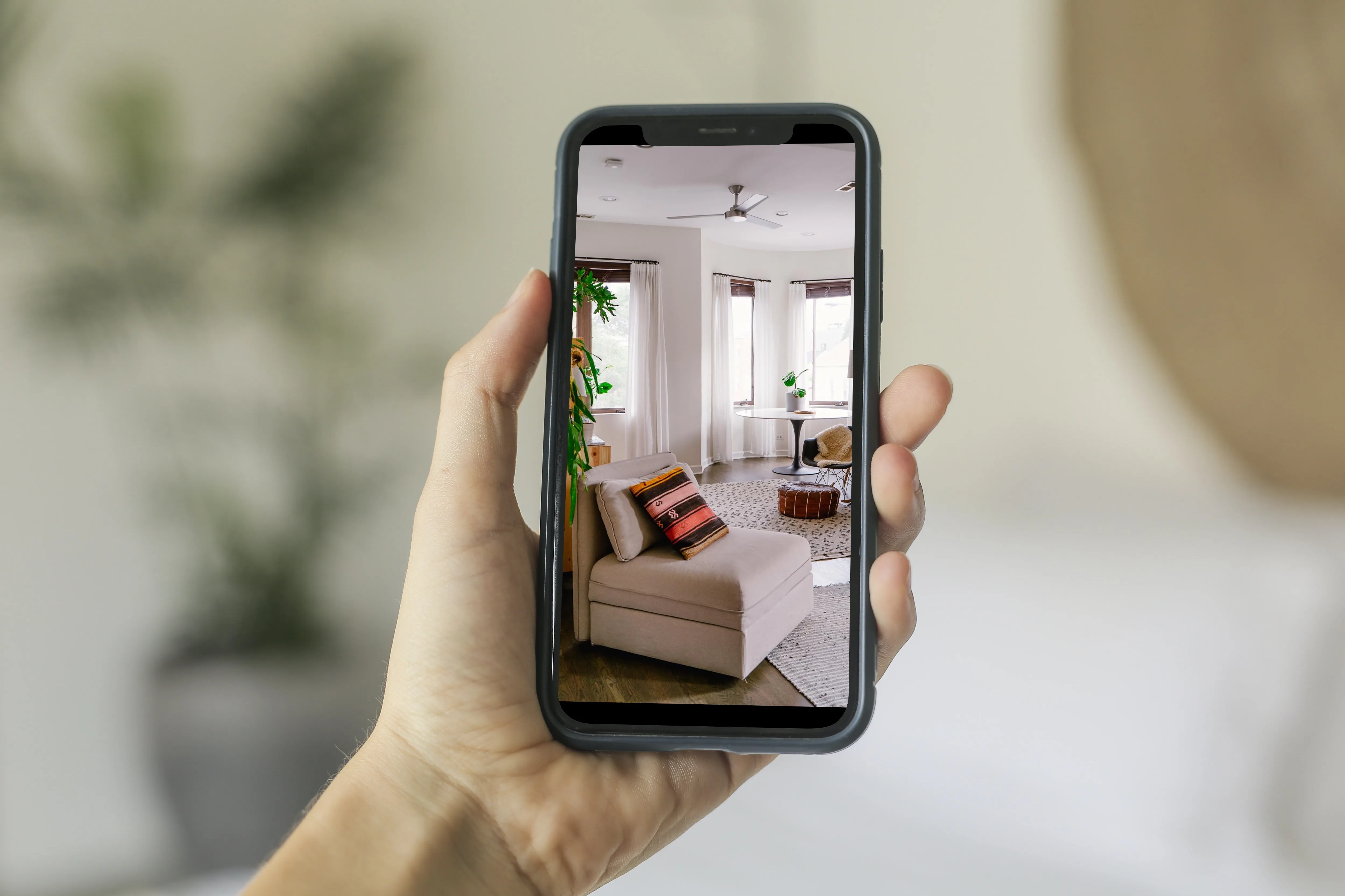 woman_holding_iphone11_taking_apartment_photo_hires