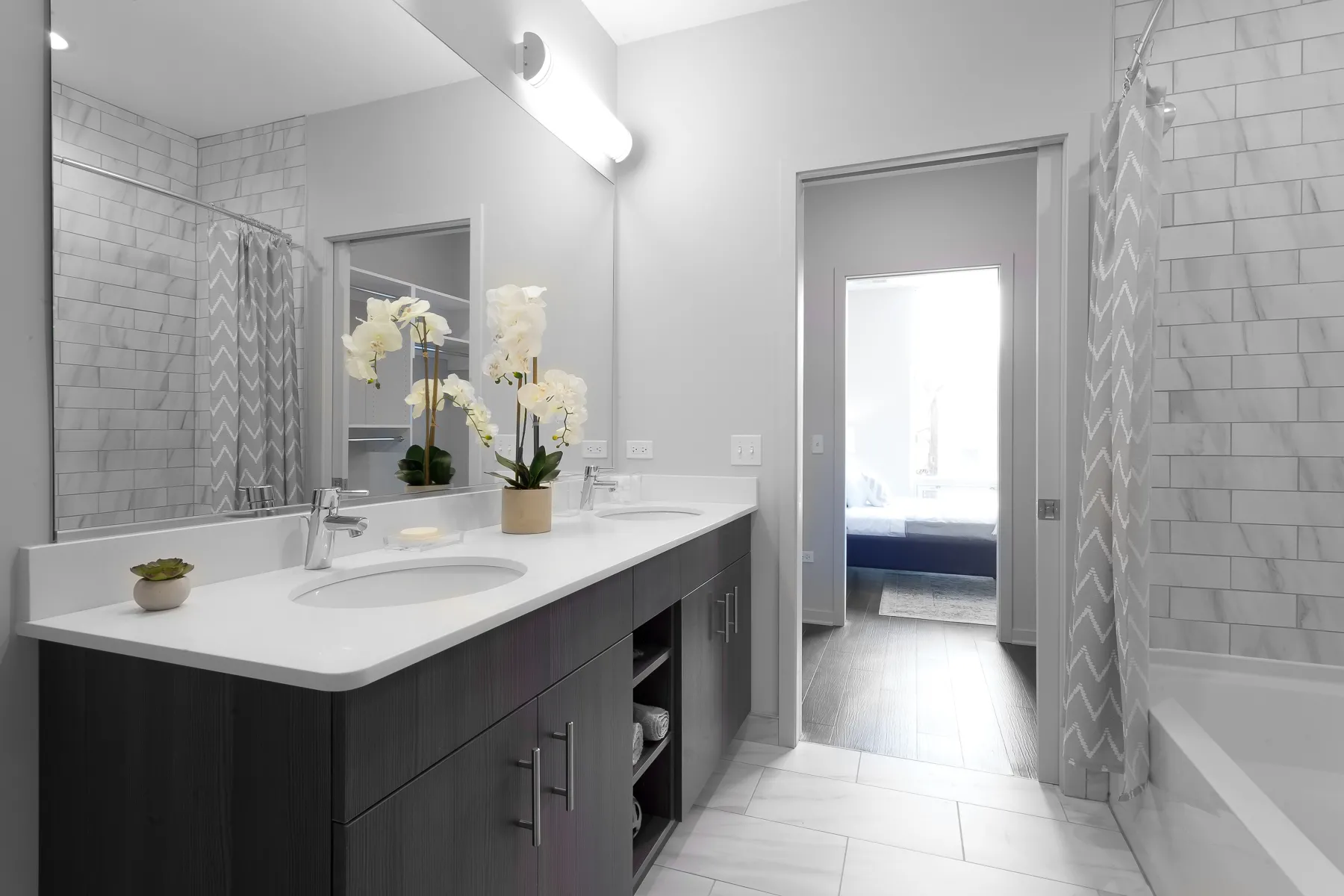 kitchen island with stool and couch at Luxe On Chicago Apartments