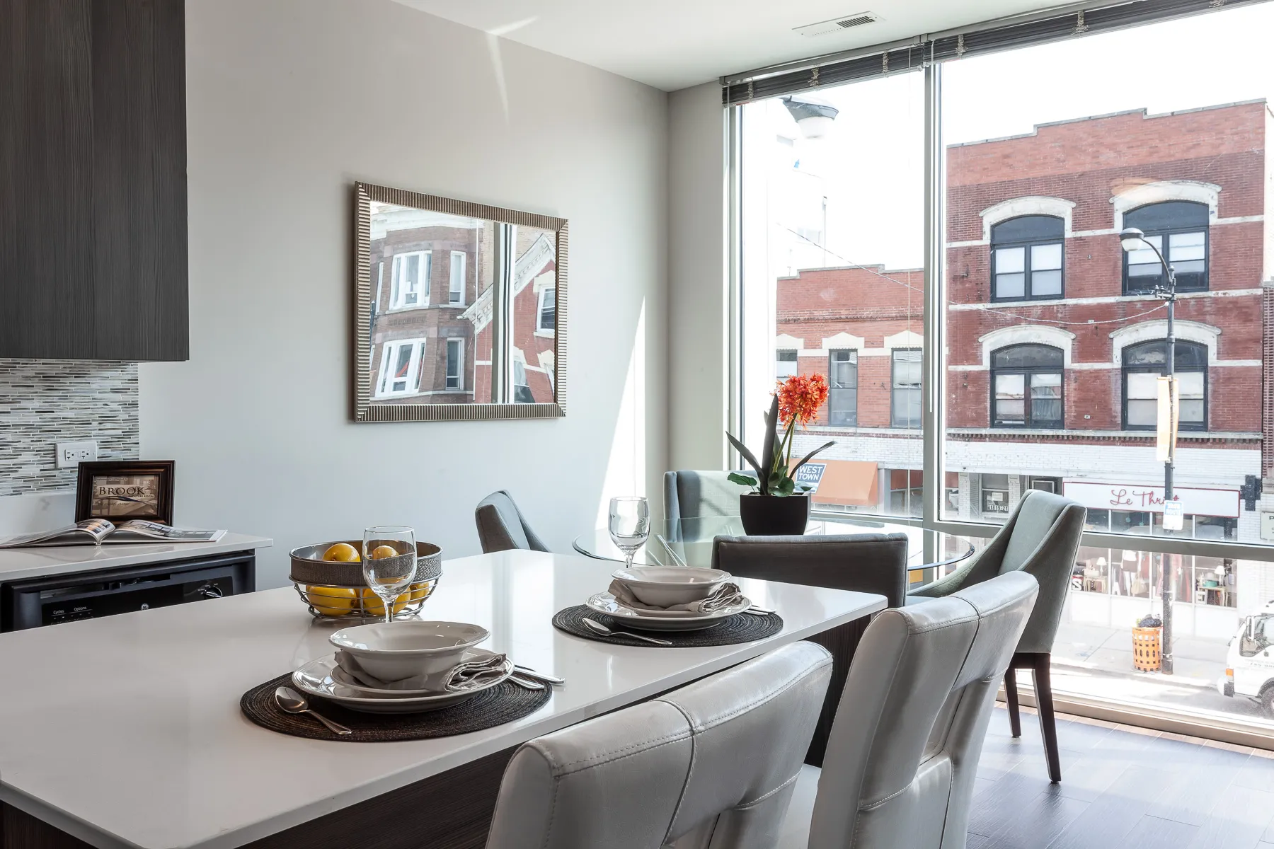 kitchen island with stool and couch at Luxe On Chicago Apartments