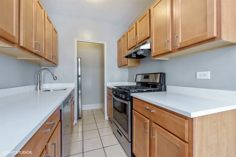 one bedroom living room with wood flooring at 1033 West Loyola Apartments