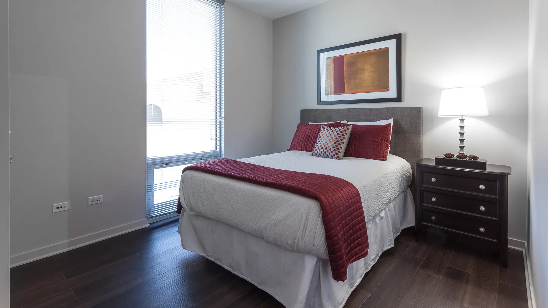 kitchen island with stool and couch at Luxe On Chicago Apartments