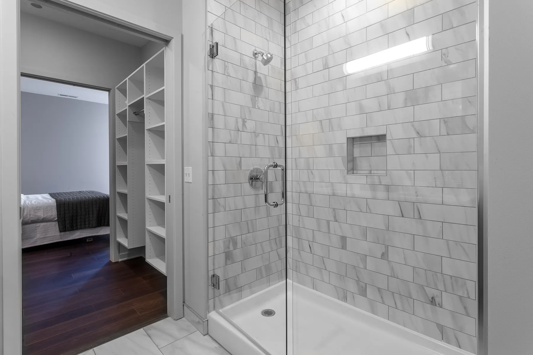 kitchen island with stool and couch at Luxe On Chicago Apartments
