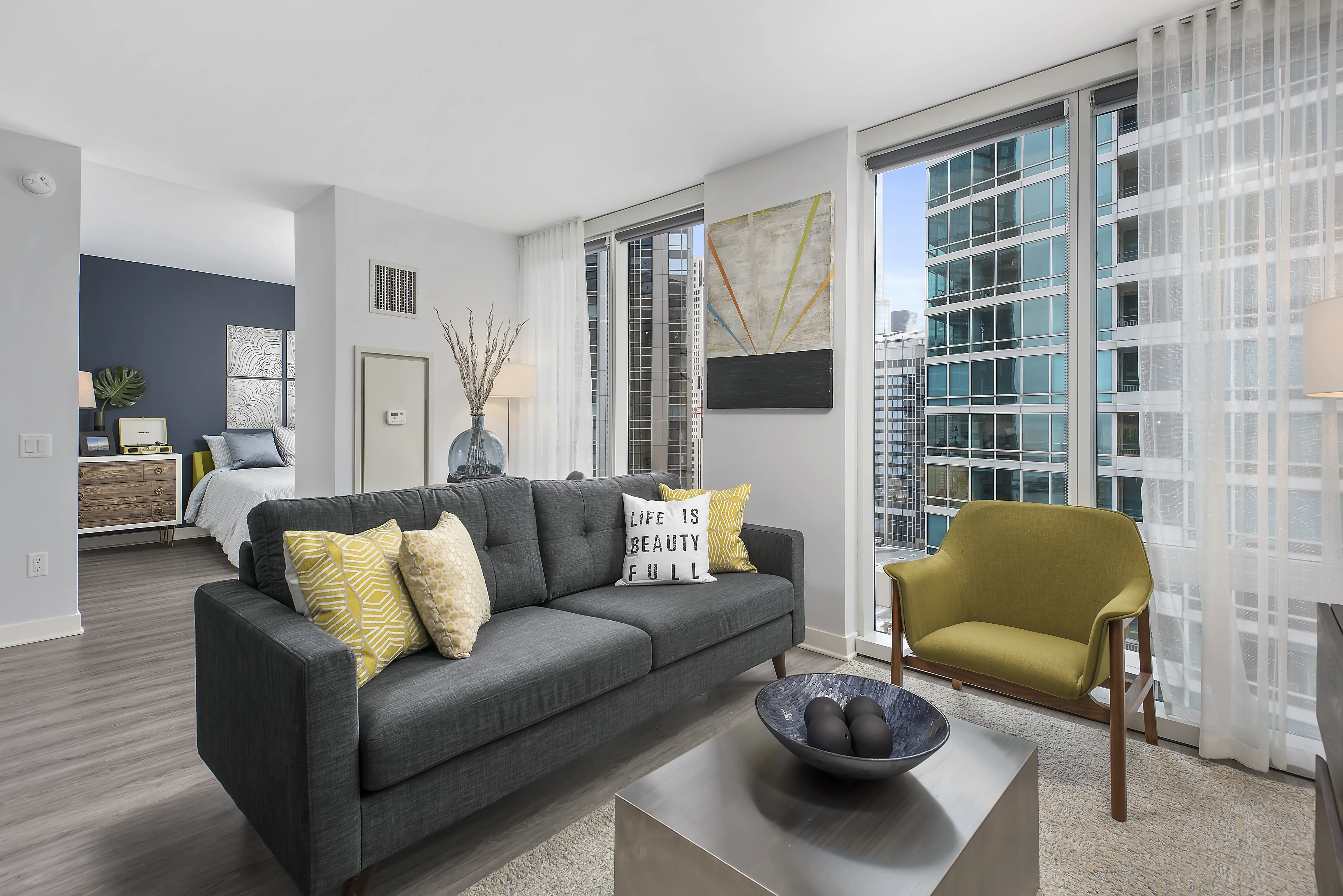 living room with brown couch at Moment Apartments in Streeterville Chicago