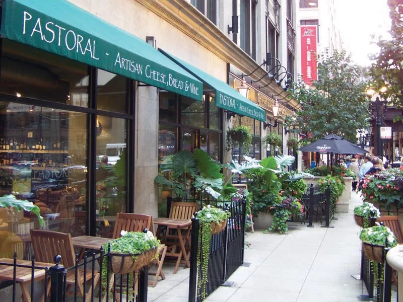 entrance to MDA City Club Apartments with red bench a flowers in pot
