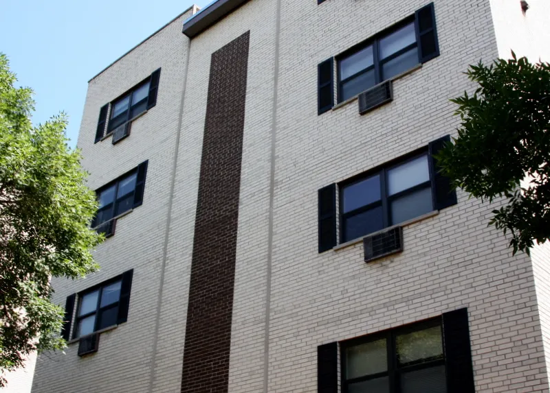 exterior of Sheridan Terrace Apartments with trees in front
