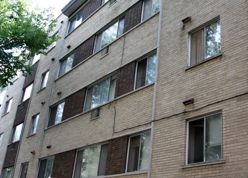 tree in front of tan brick building at 5620 N Kenmore Apartments