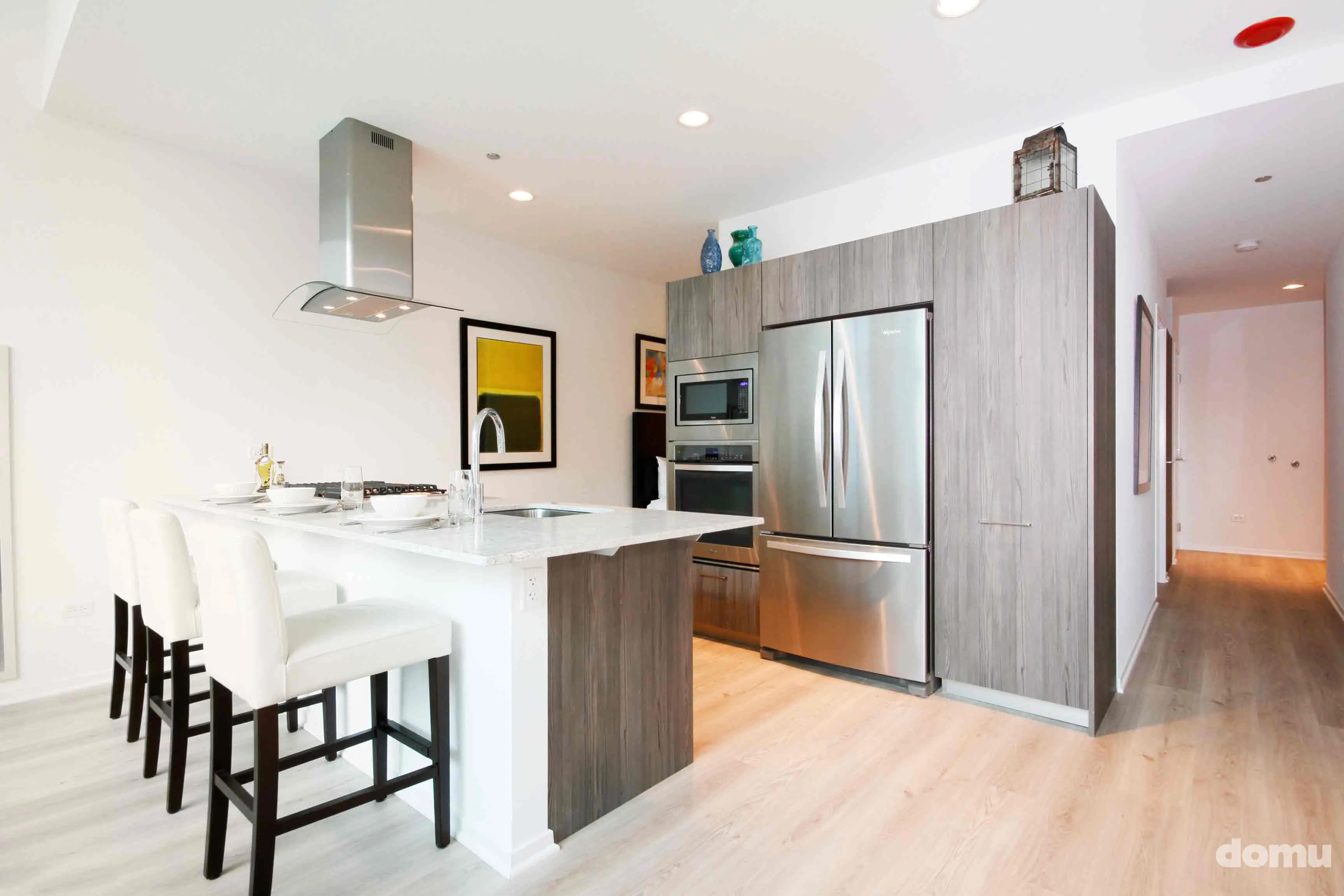 model kitchen with view of Chicago at Optima Signature Apartments
