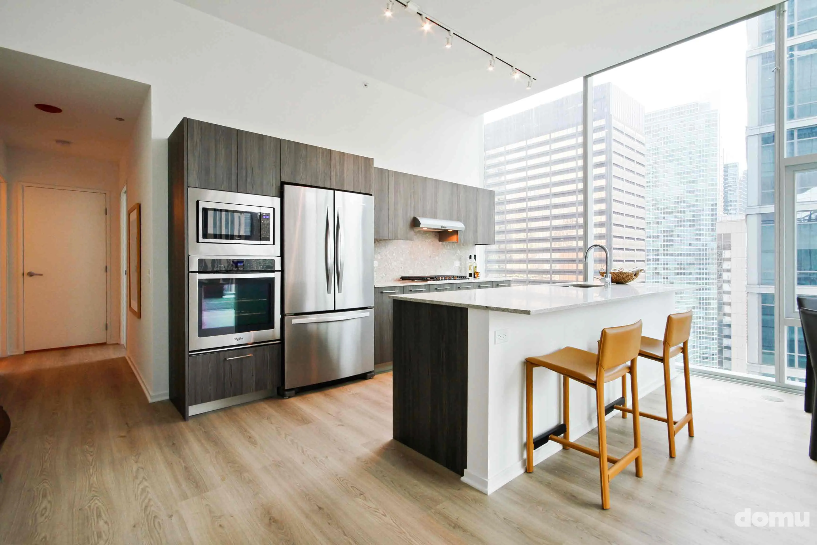 model kitchen with view of Chicago at Optima Signature Apartments