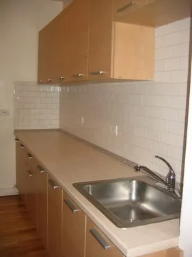 model kitchen with wood floors at 822-836 South Austin Apartments