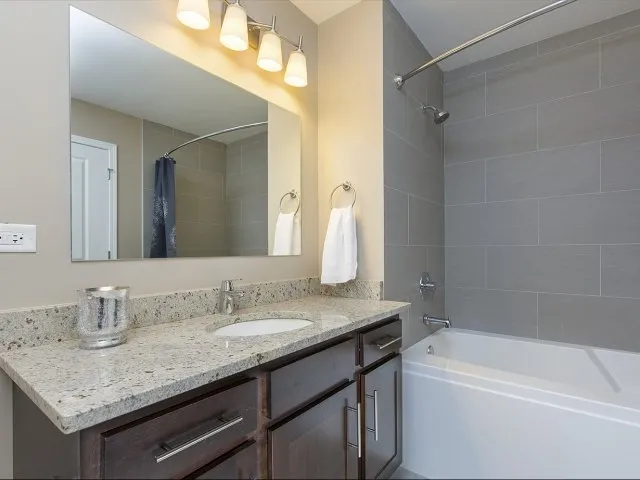 modern kitchen with brown wood cabints at The Shelby Apartments in Chicago