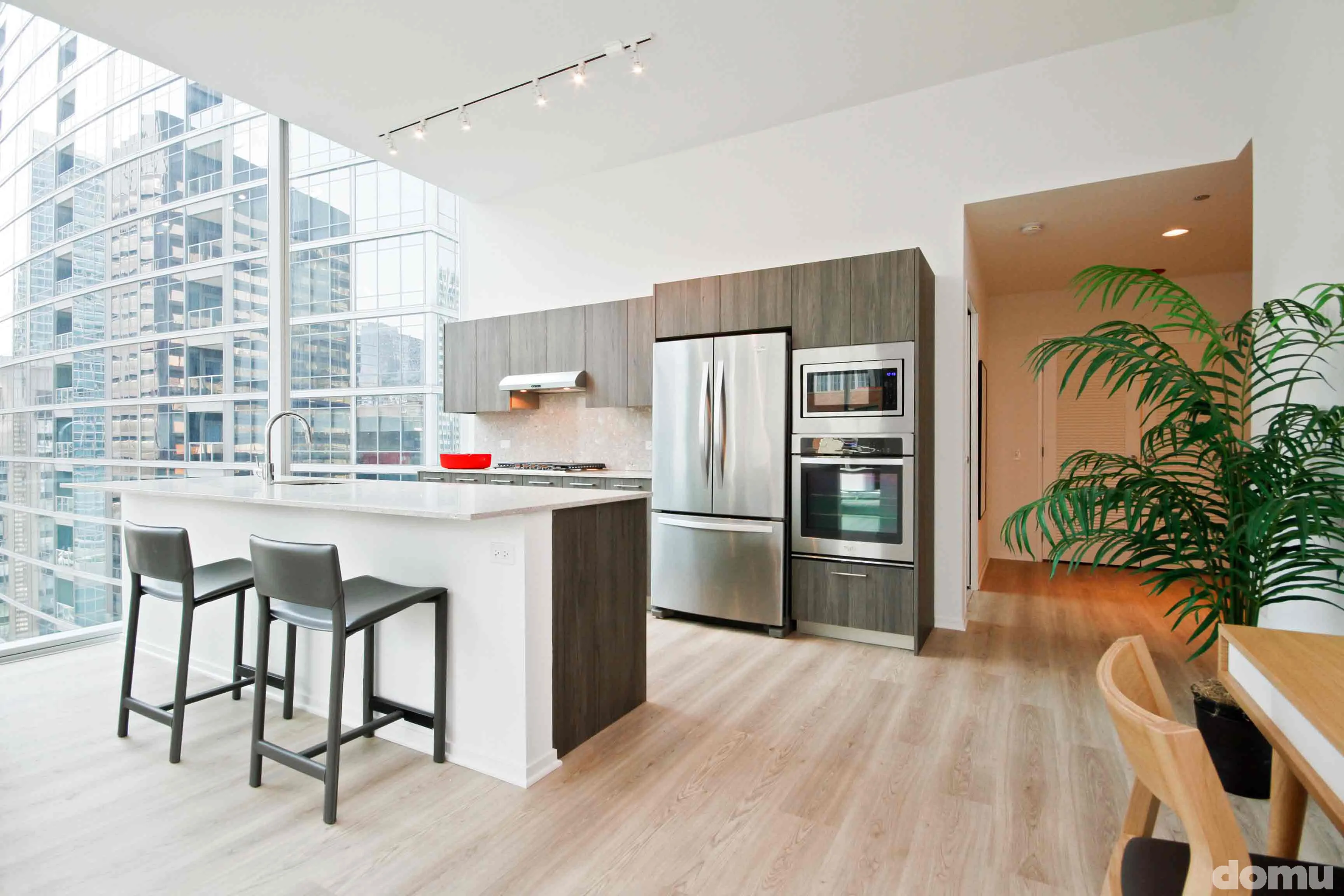 model kitchen with view of Chicago at Optima Signature Apartments