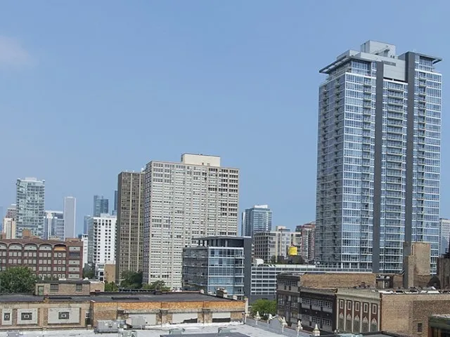 modern kitchen with brown wood cabints at The Shelby Apartments in Chicago