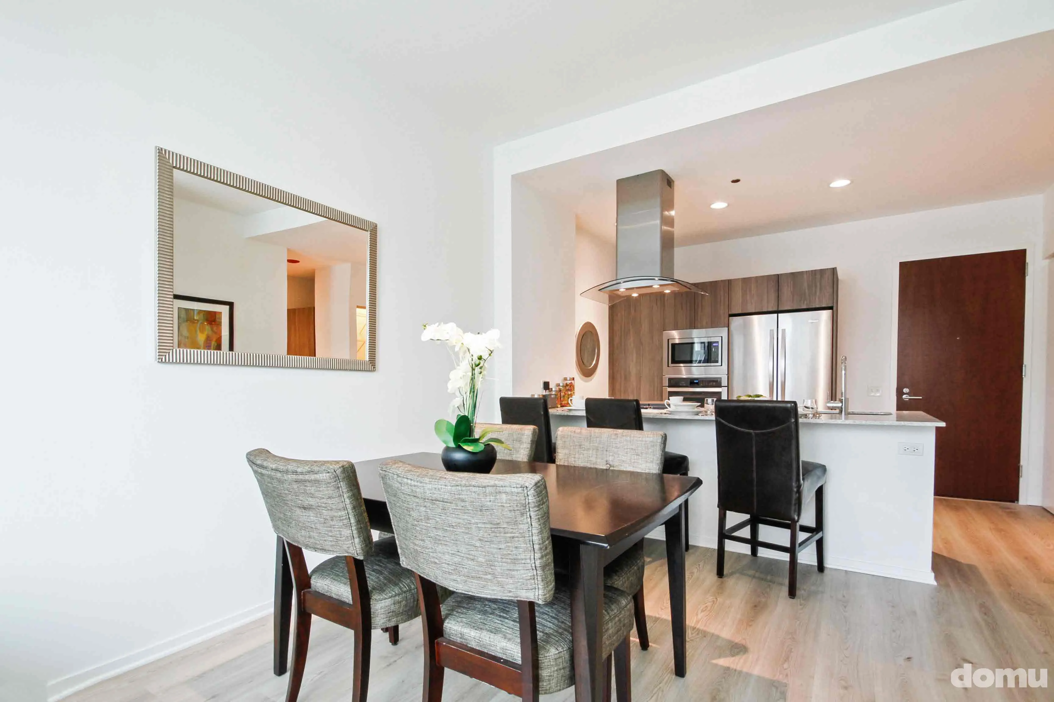model kitchen with view of Chicago at Optima Signature Apartments