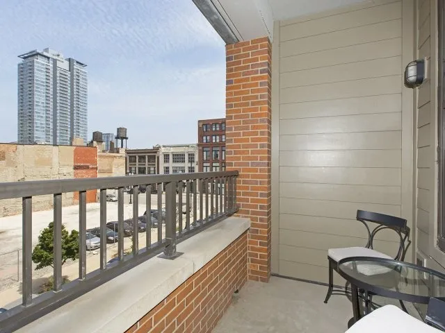 modern kitchen with brown wood cabints at The Shelby Apartments in Chicago