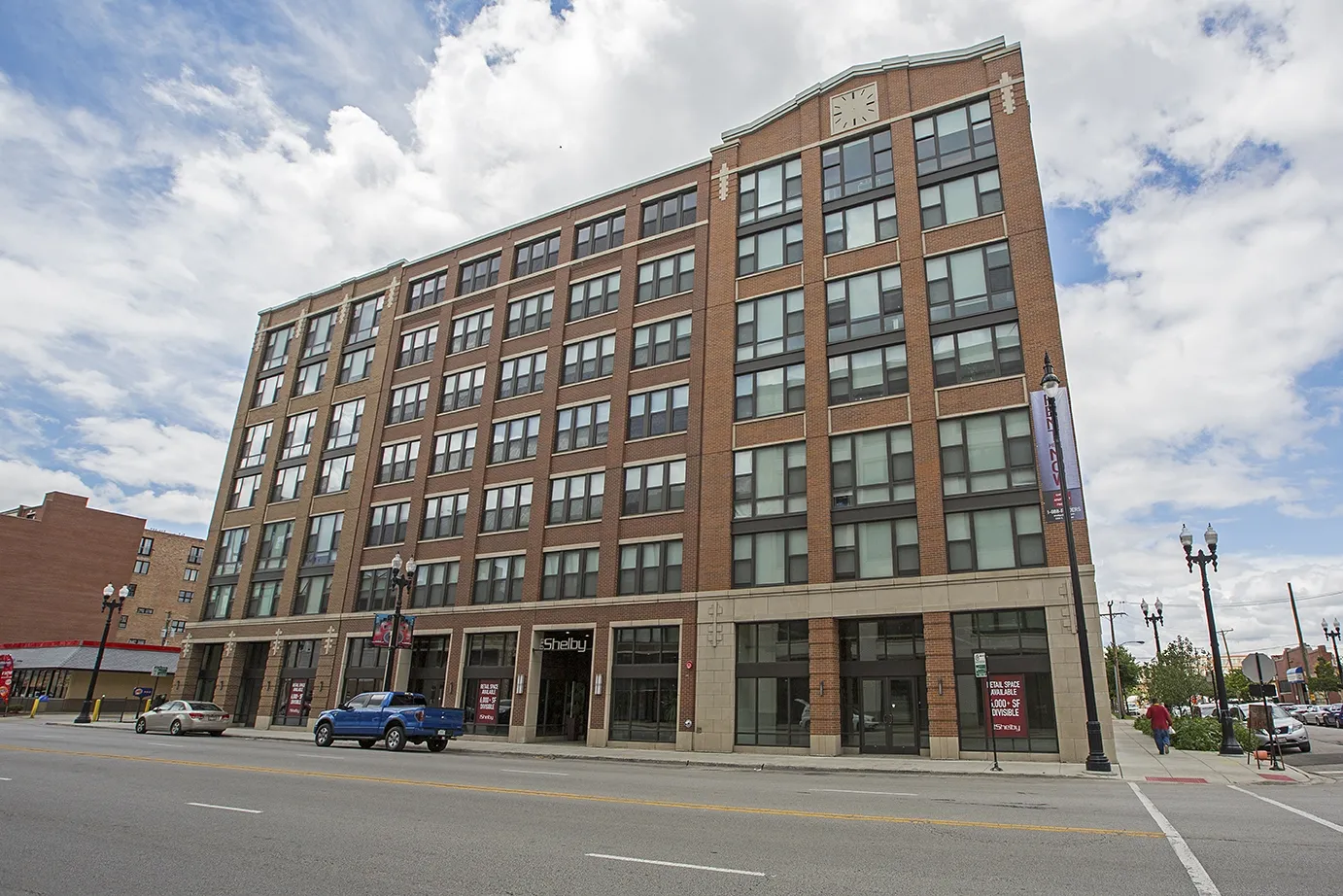 modern kitchen with brown wood cabints at The Shelby Apartments in Chicago