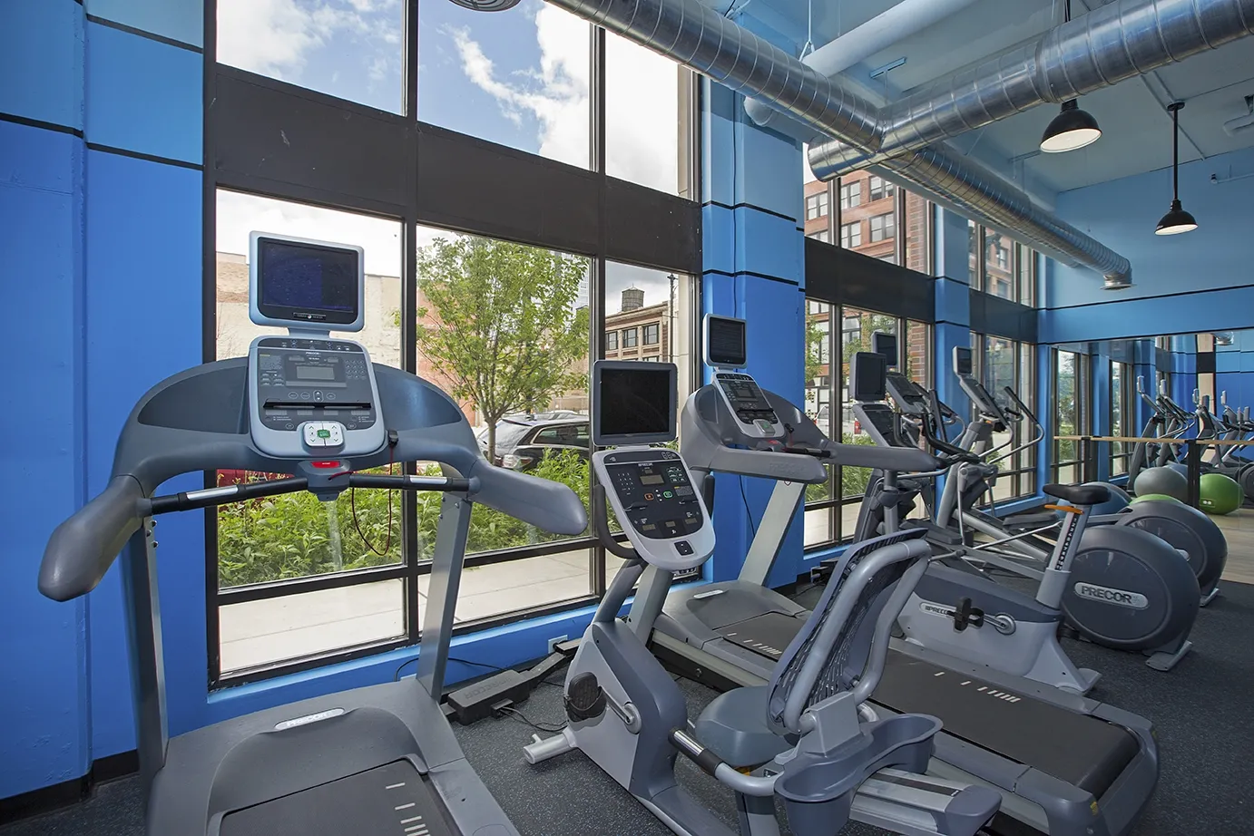 modern kitchen with brown wood cabints at The Shelby Apartments in Chicago