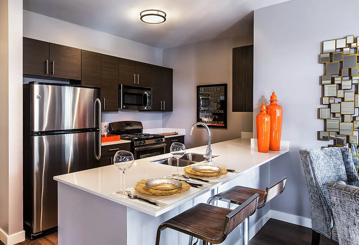 kitchen with view of living room at The Madison at Racine Apartments