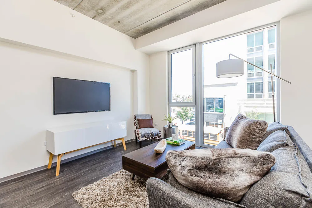 kitchena nd living area with wood floors at The Western 1920 Apartments