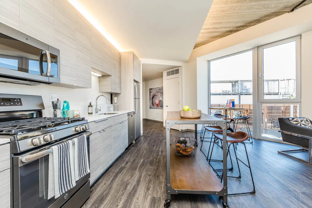 kitchena nd living area with wood floors at The Western 1920 Apartments