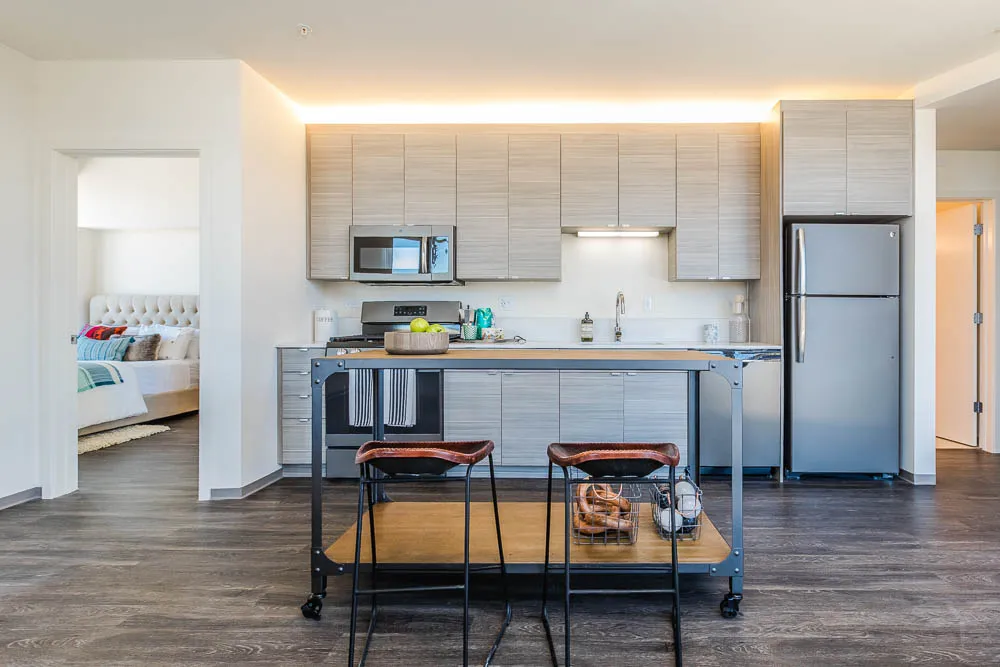 kitchena nd living area with wood floors at The Western 1920 Apartments