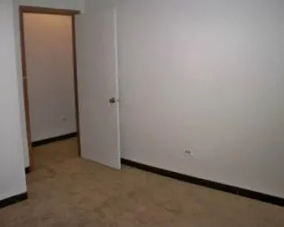 the grass and landscaped courtyard of The Dickens Courtyard Apartments