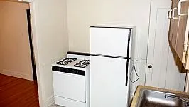 tress and brick front of 4551-4553 N Claremont Apartments