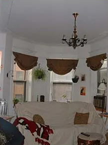 graystone facade of three story 450 W St James Place Apartments