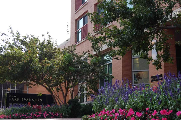 flowers surround the entrance of The Park Evanston Apartments in Evanston