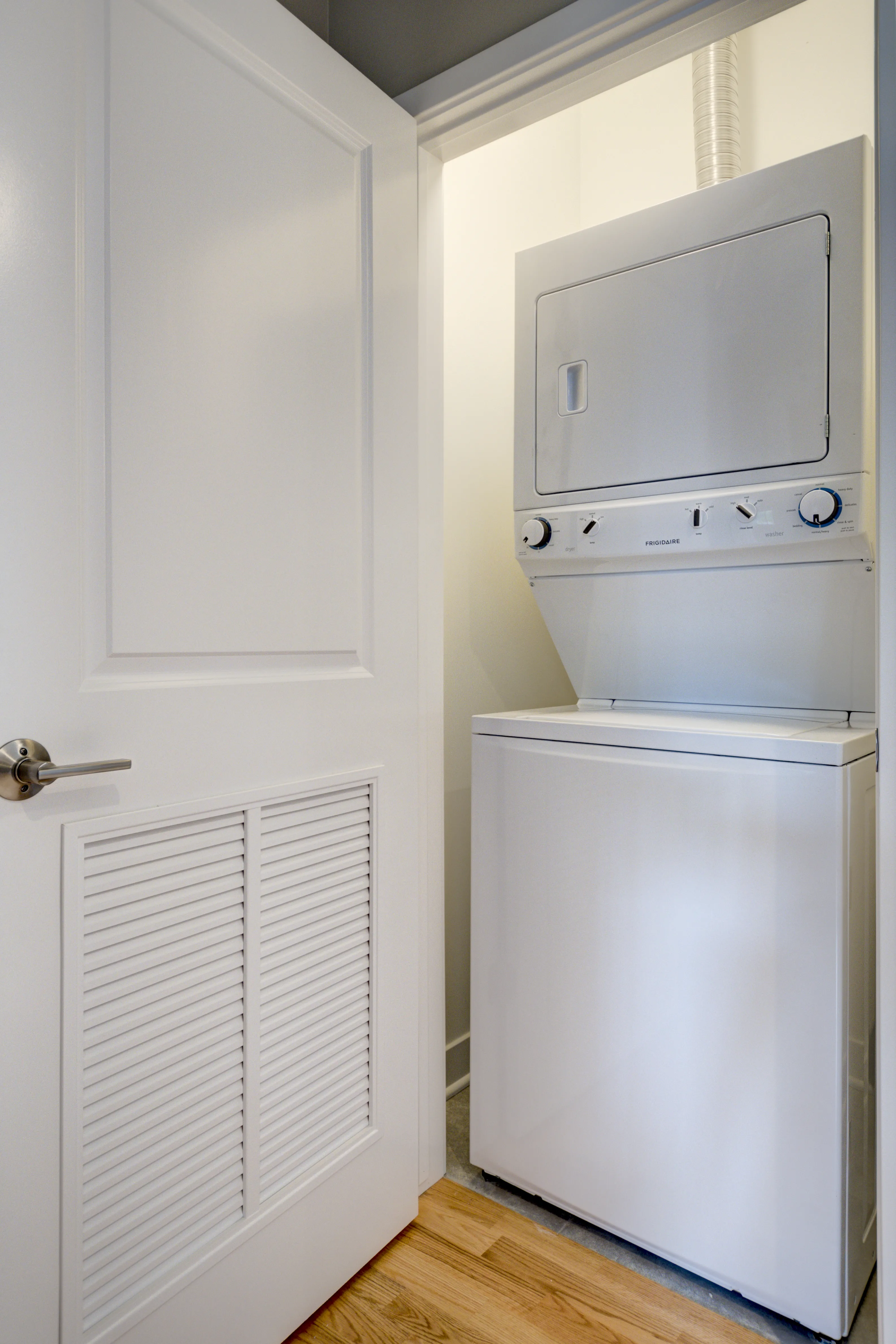 empty model living room with wood floors at 6125 North Clark Apartments