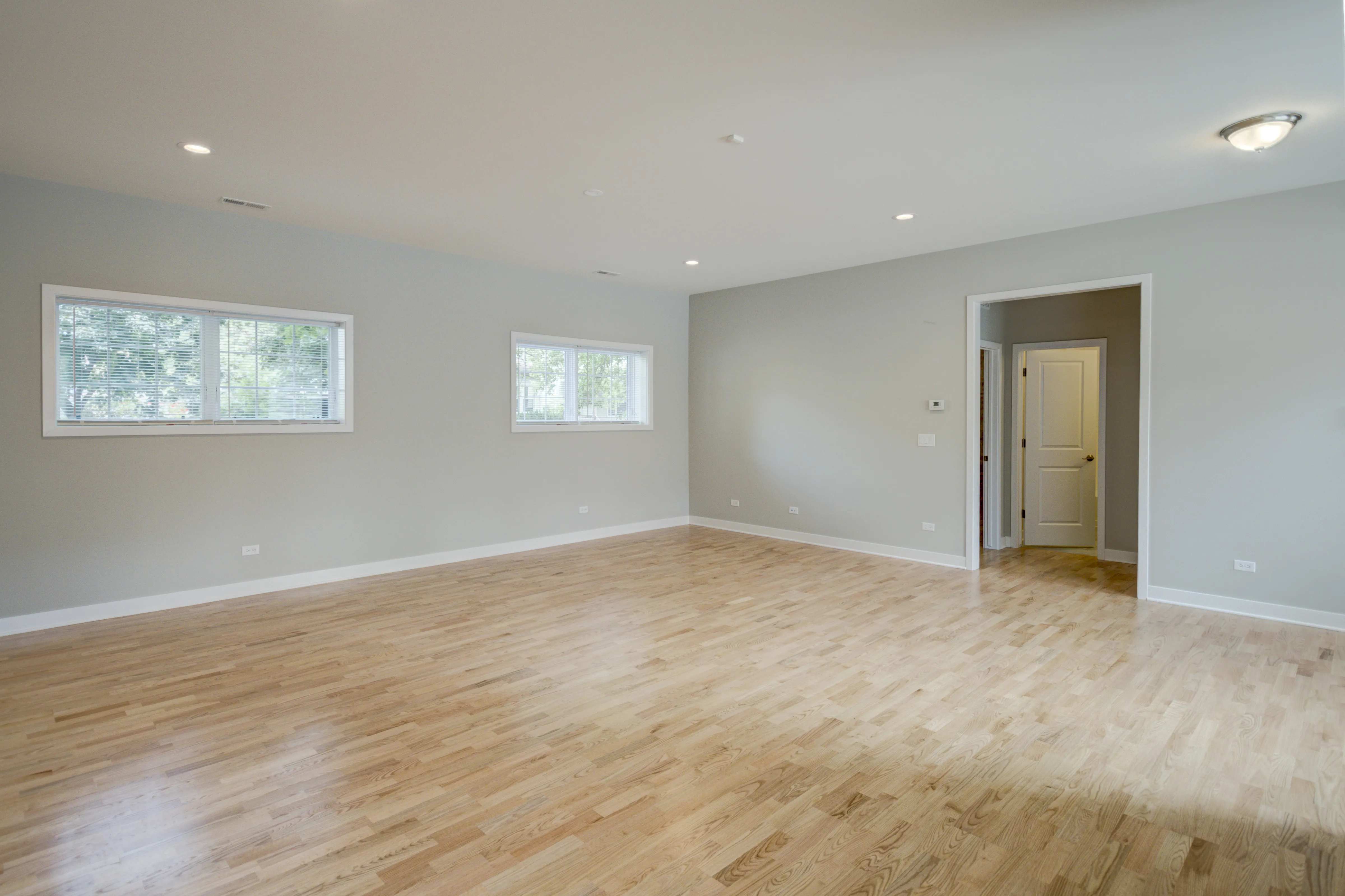 empty model living room with wood floors at 6125 North Clark Apartments