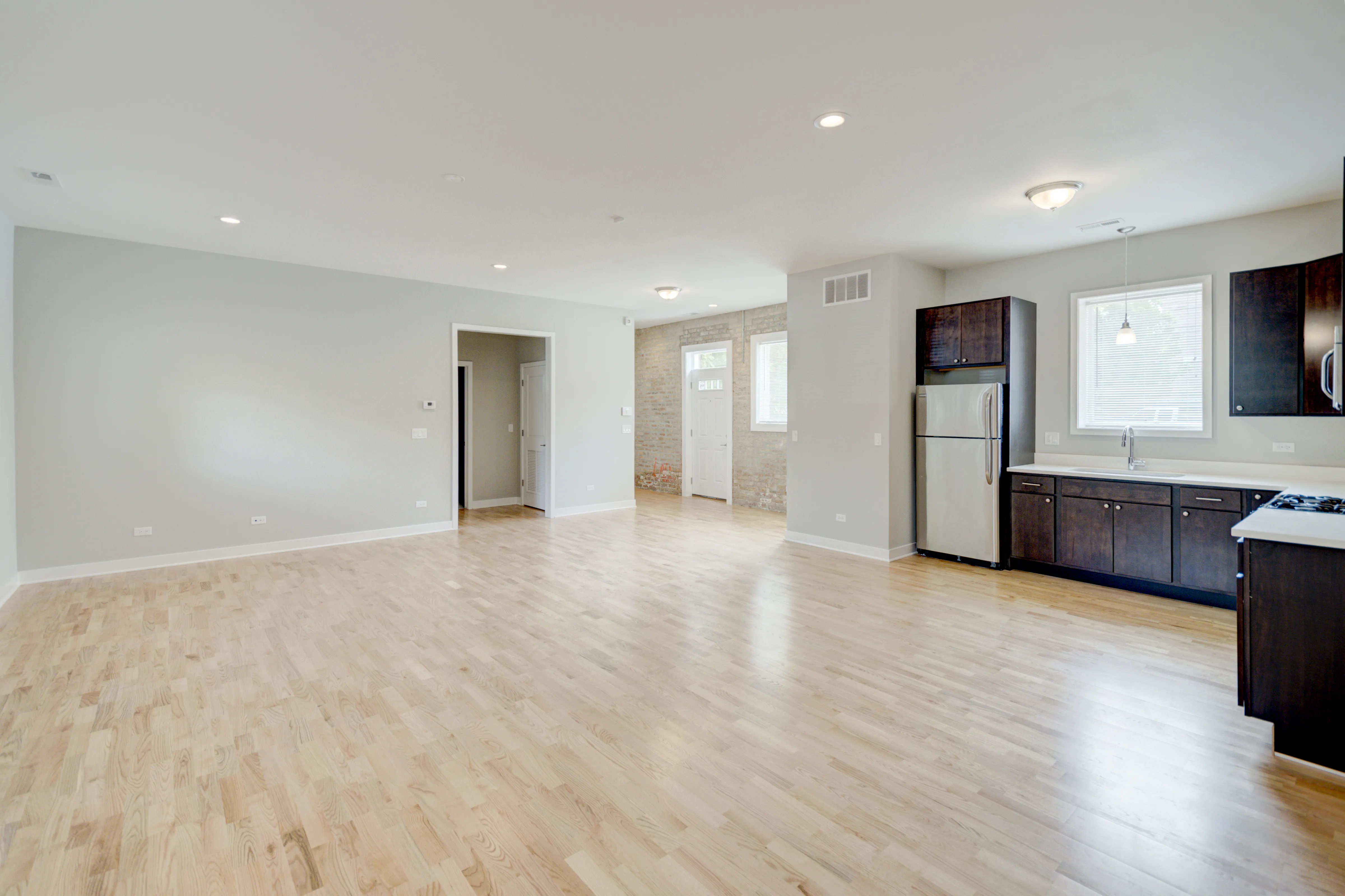 empty model living room with wood floors at 6125 North Clark Apartments