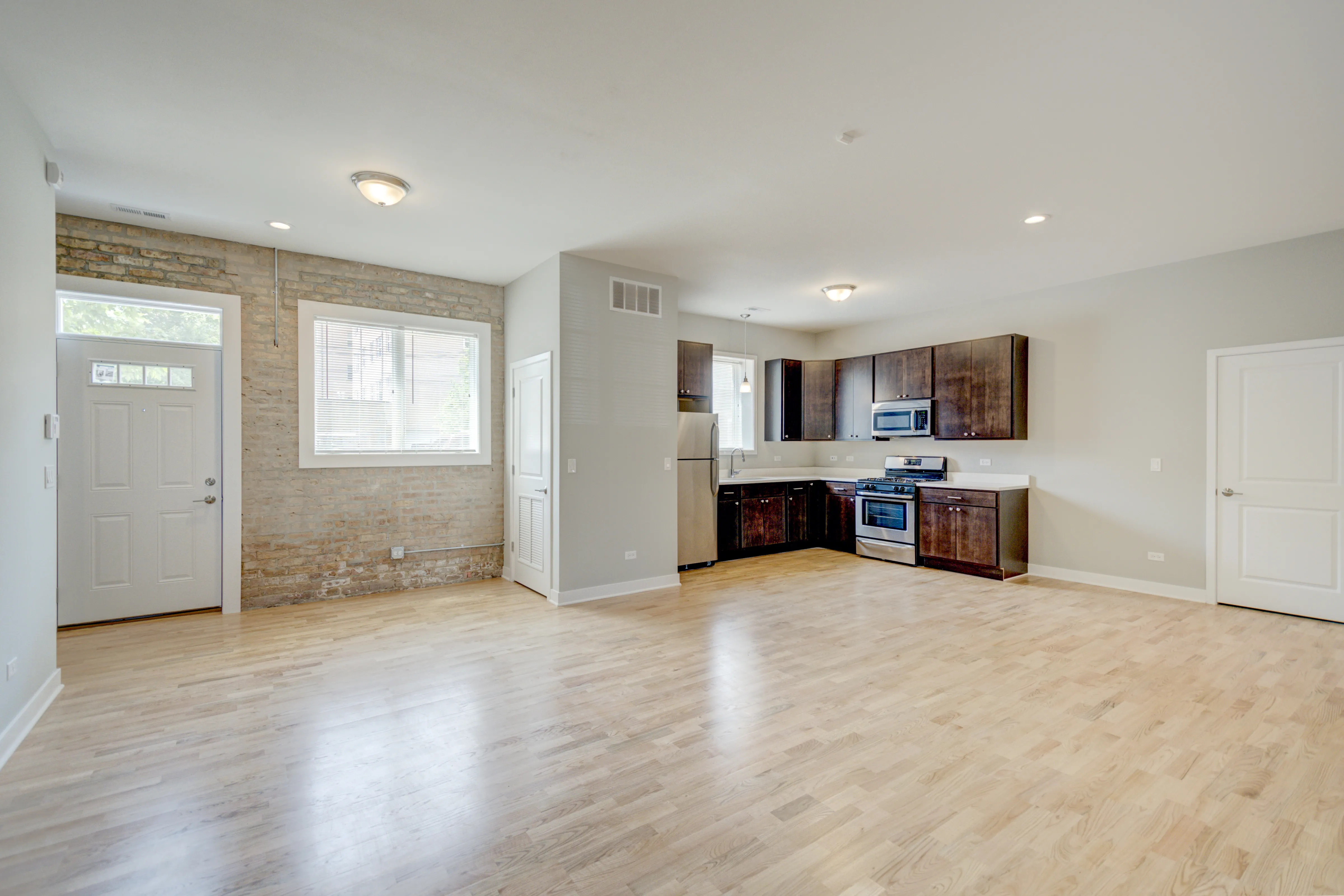 empty model living room with wood floors at 6125 North Clark Apartments