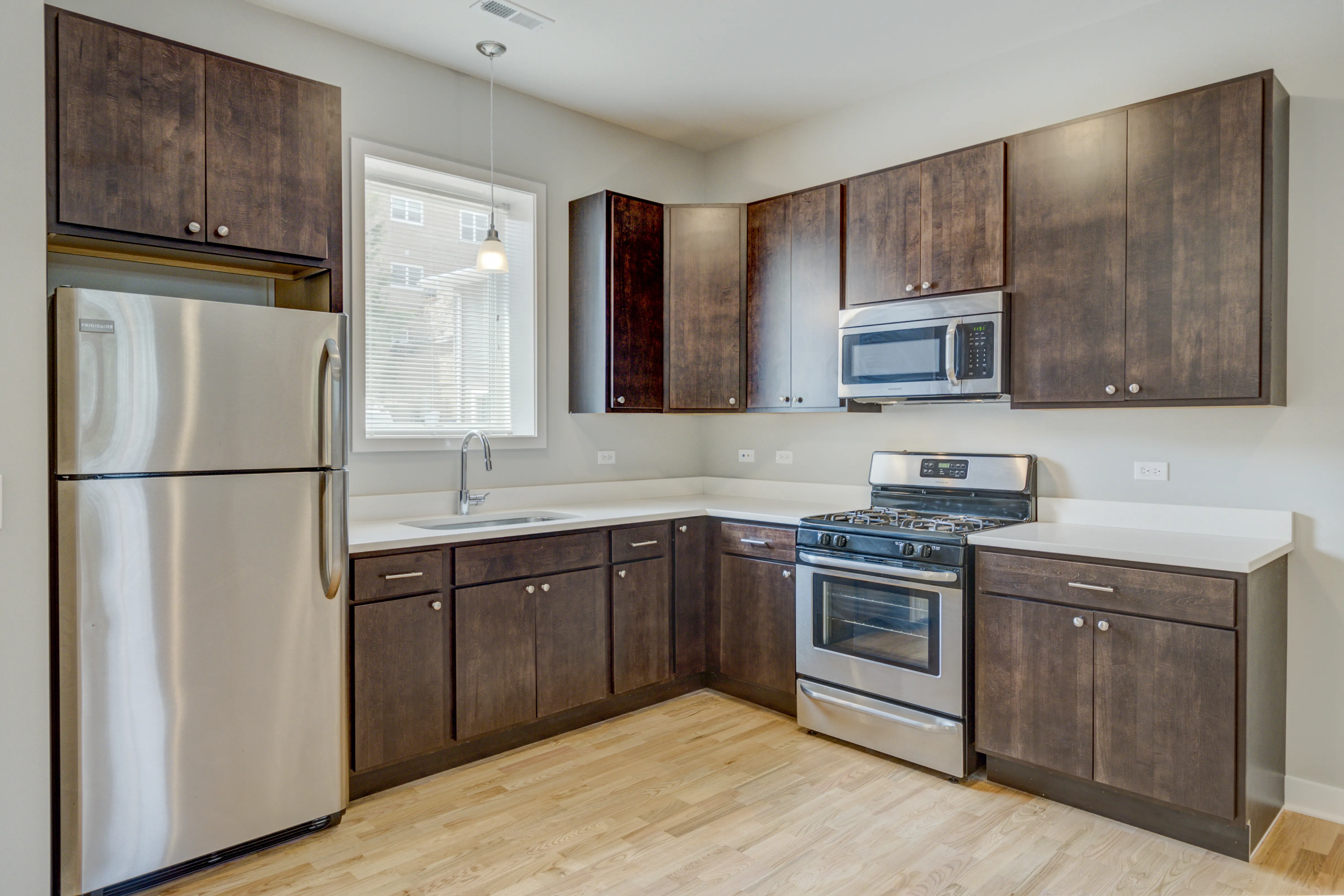 empty model living room with wood floors at 6125 North Clark Apartments