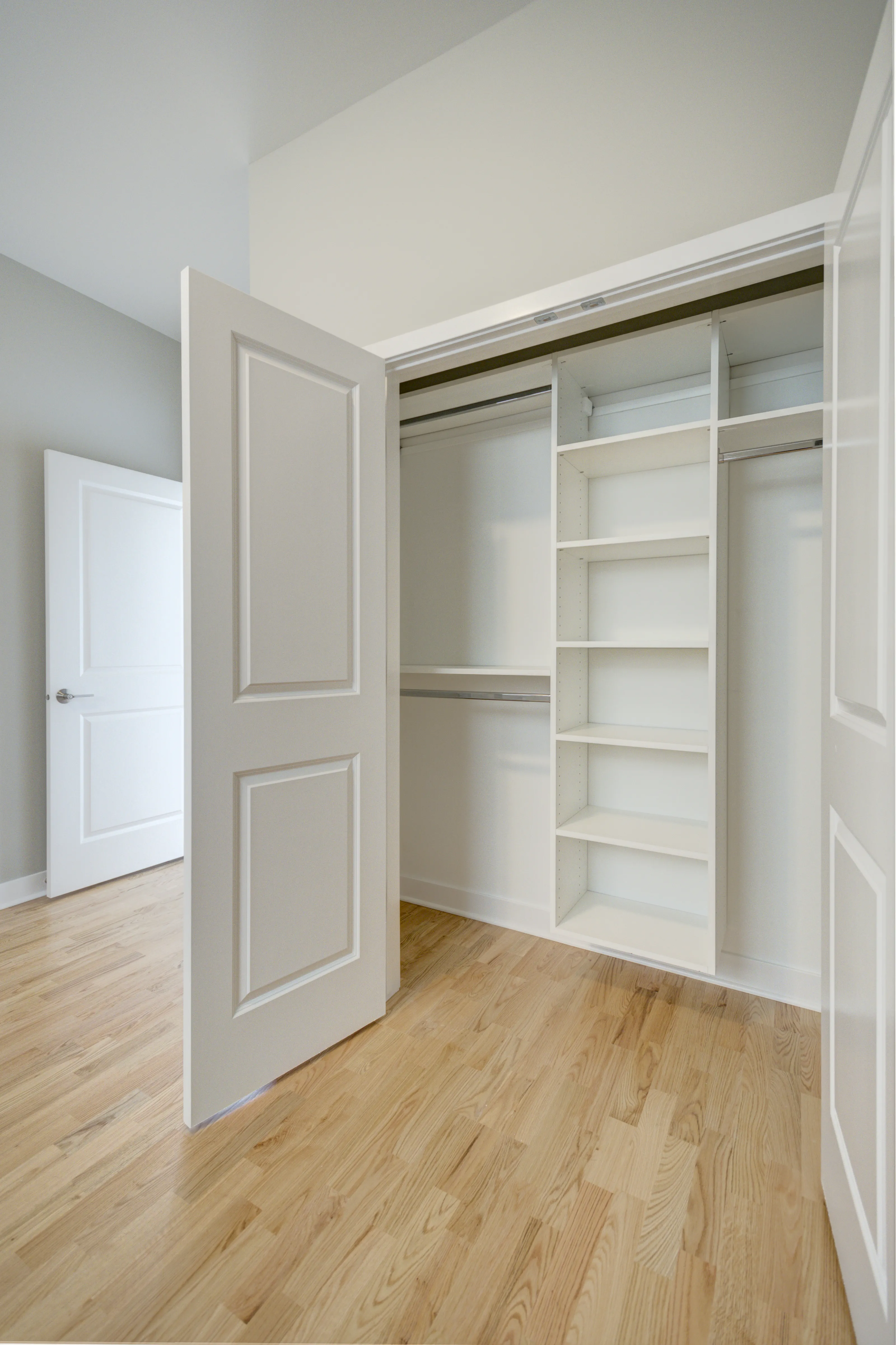 empty model living room with wood floors at 6125 North Clark Apartments