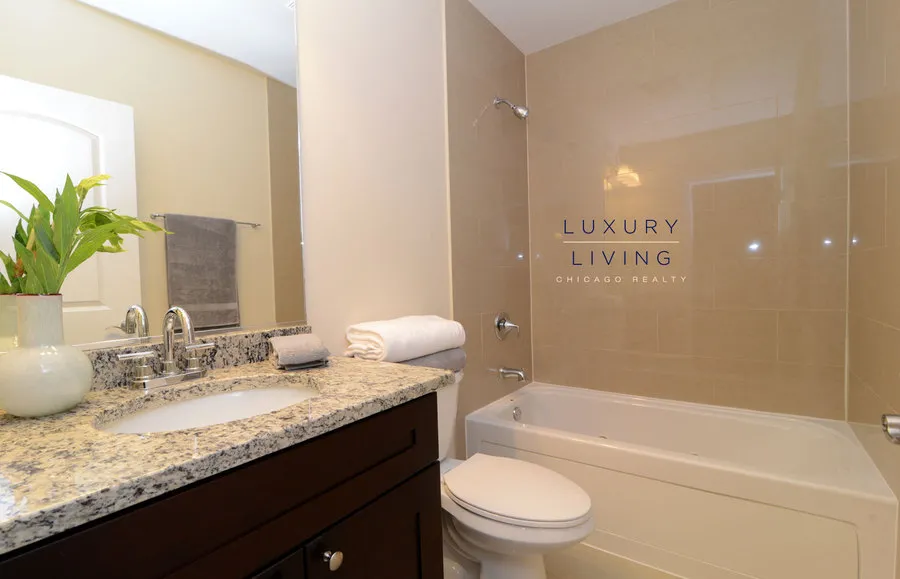 kitchen and island with wood floors at Riverview Terrace Apartments