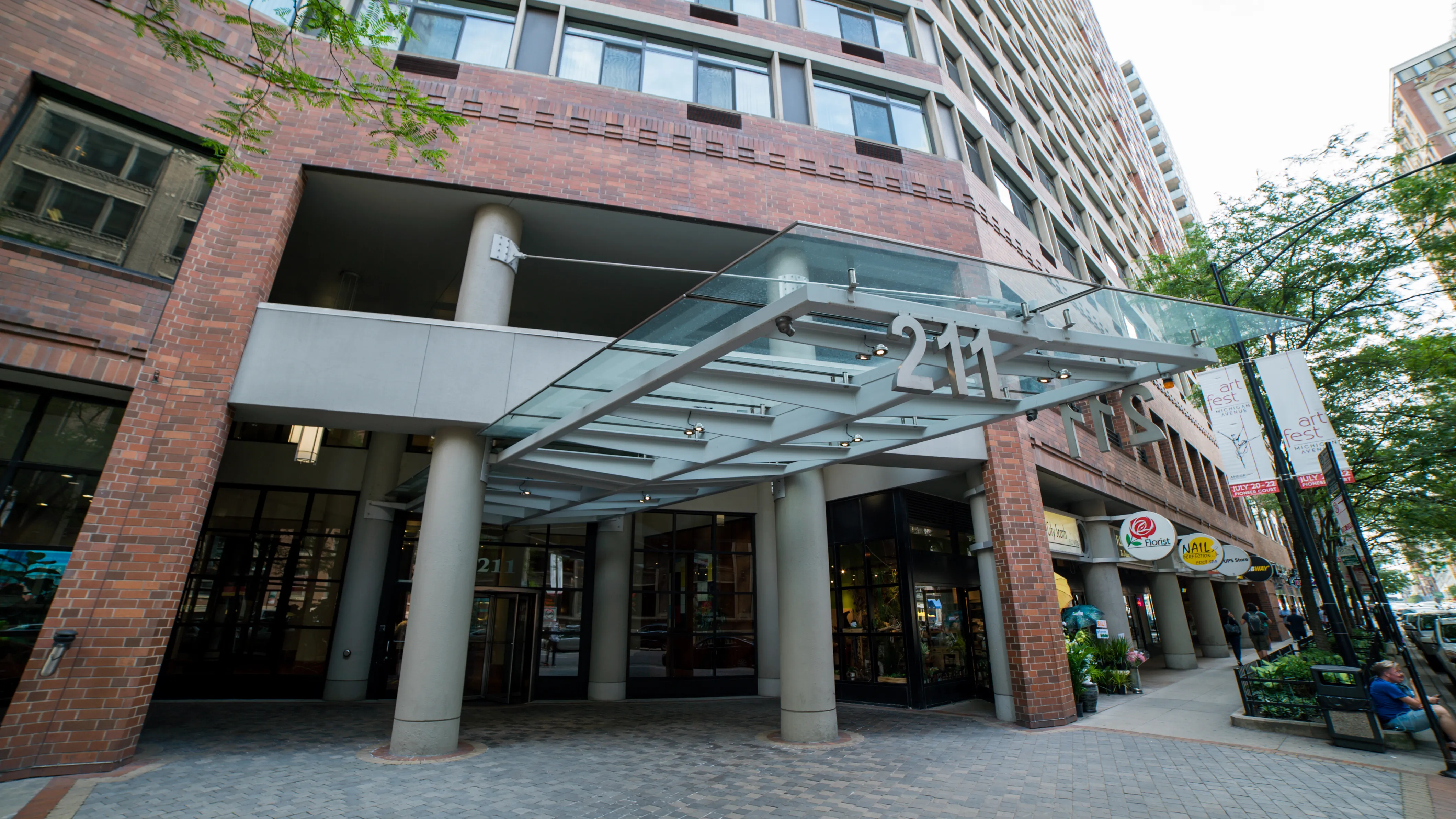 looking up at the Grand Ohio Apartments with tress in front