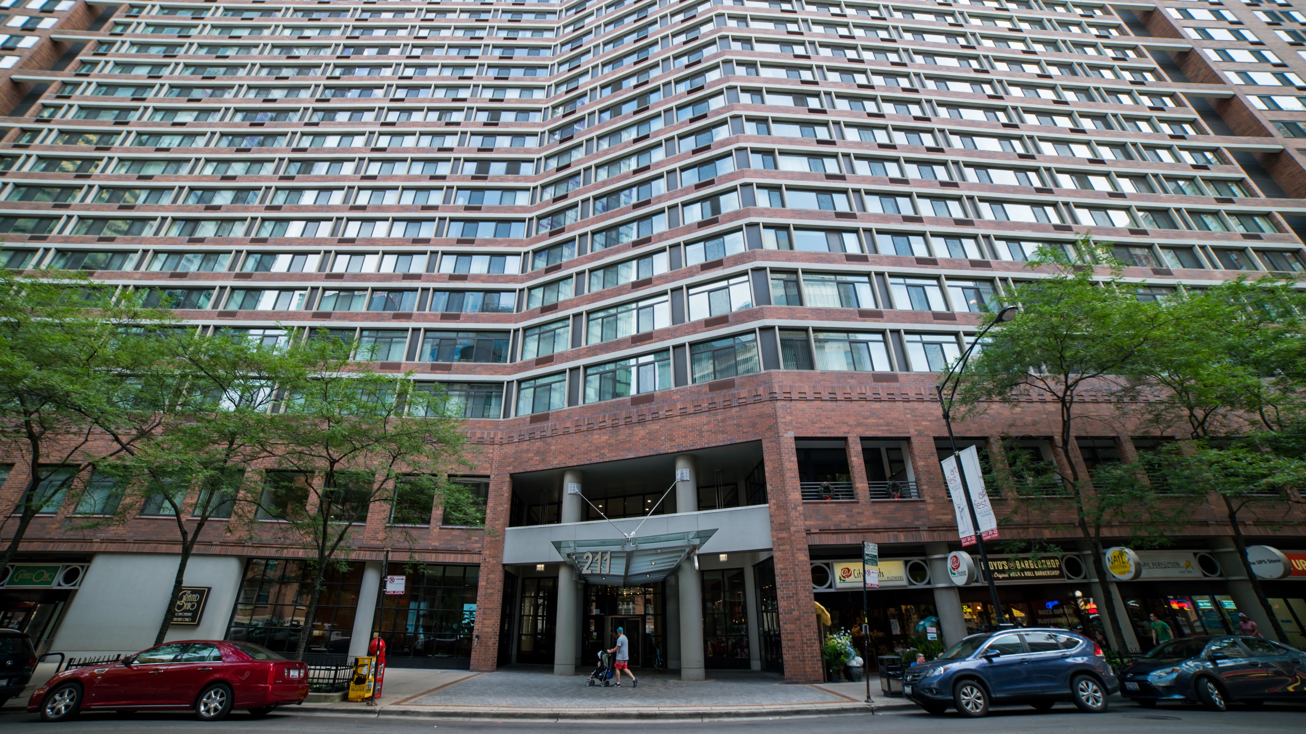 looking up at the Grand Ohio Apartments with tress in front