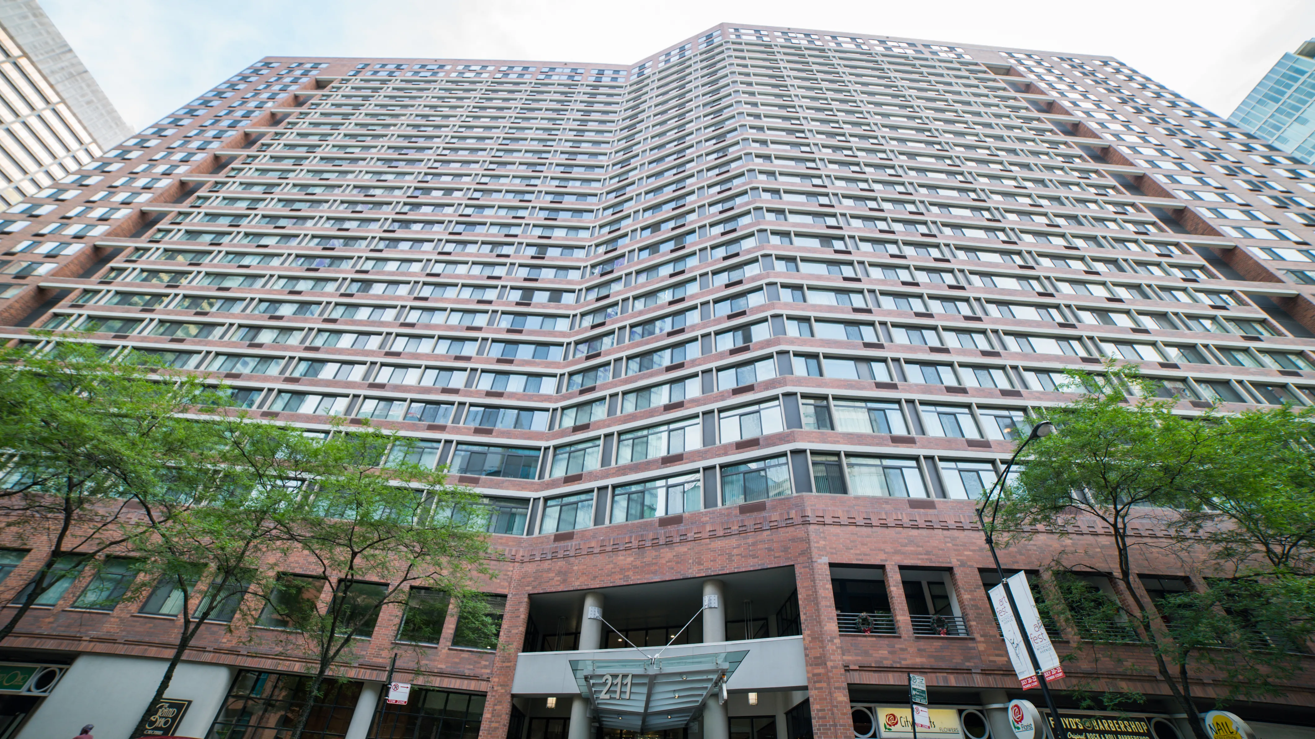 looking up at the Grand Ohio Apartments with tress in front