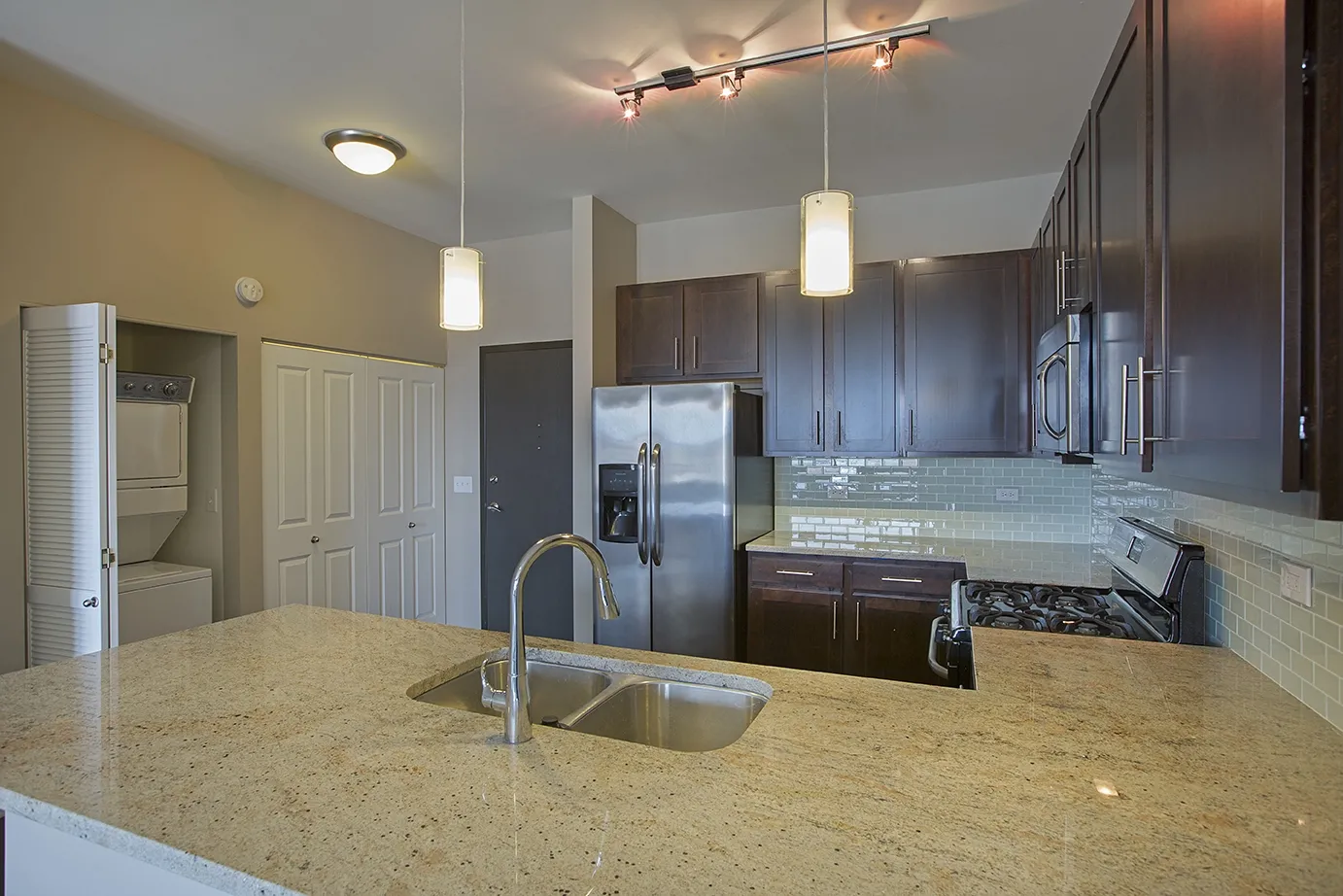 modern kitchen with brown wood cabints at The Shelby Apartments in Chicago