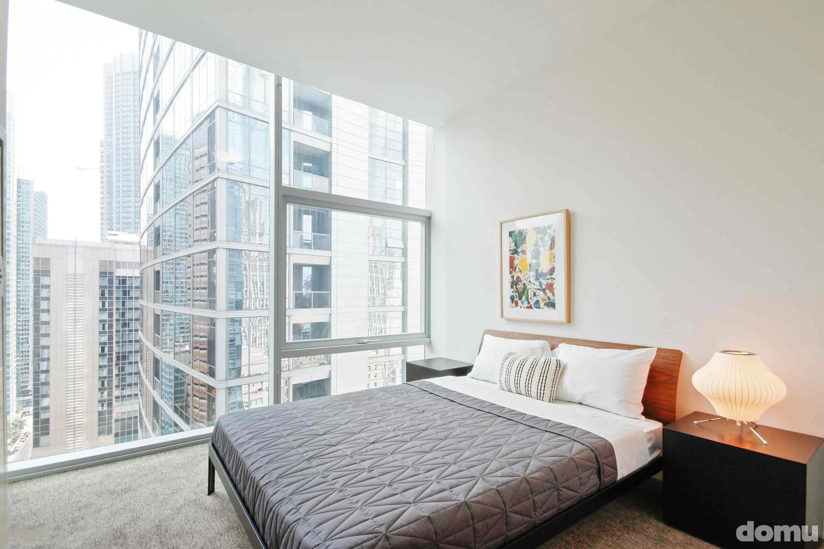 model kitchen with view of Chicago at Optima Signature Apartments